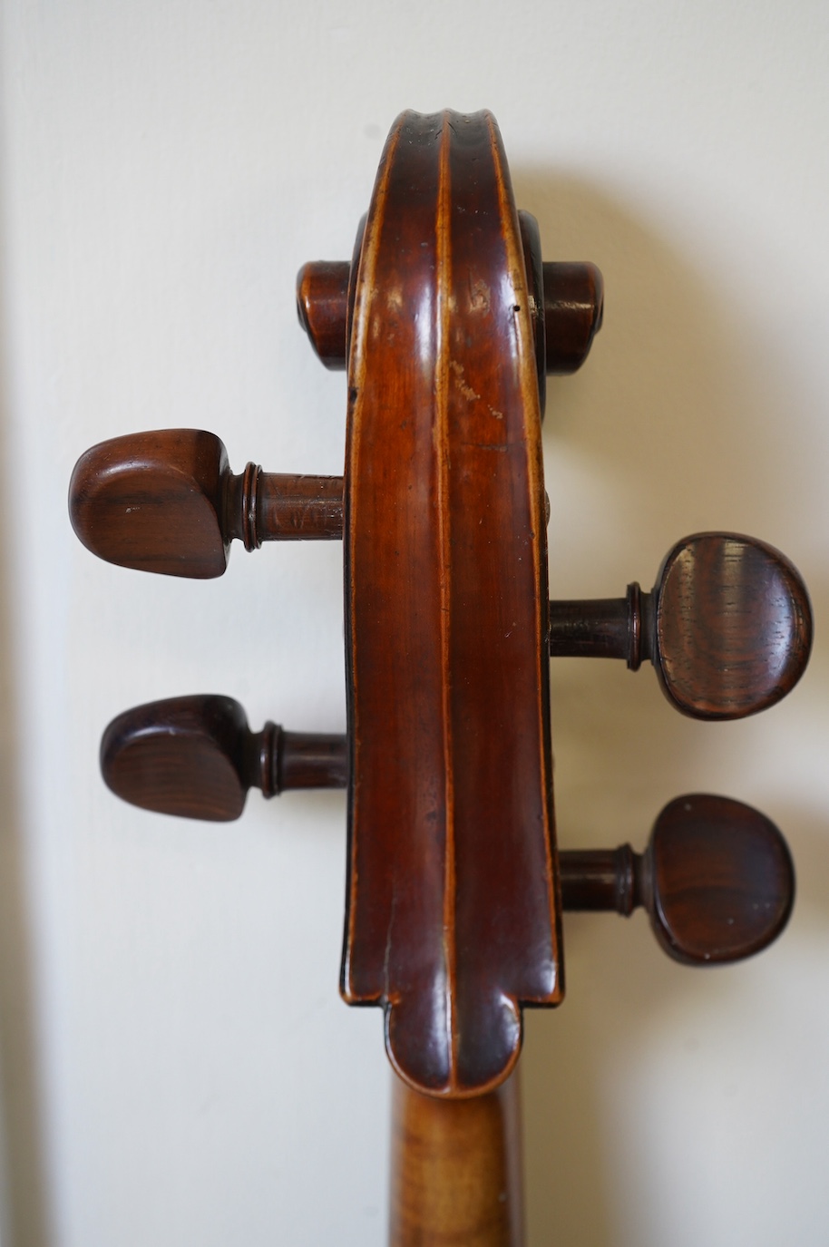 An early 19th century cello with a Stradivarius label, body 76cm, with a P&H bow, in a good modern case. Condition - poor